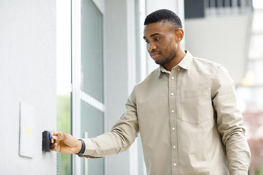 A man gaining door access control entry by using a key card