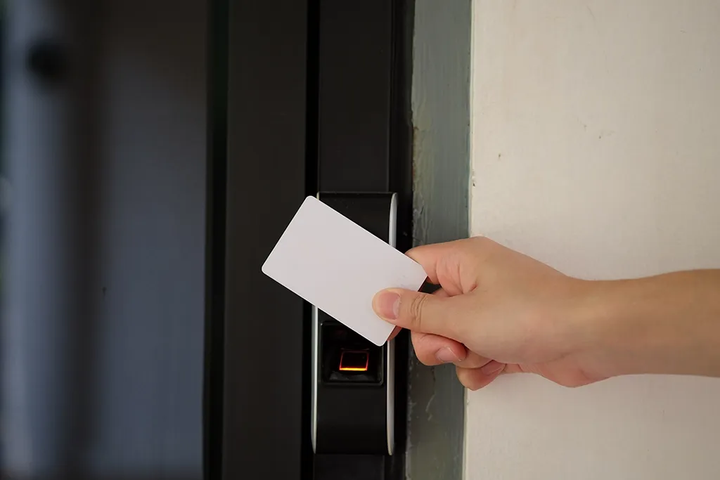 An access control key card being used to gain access to an internal fire door