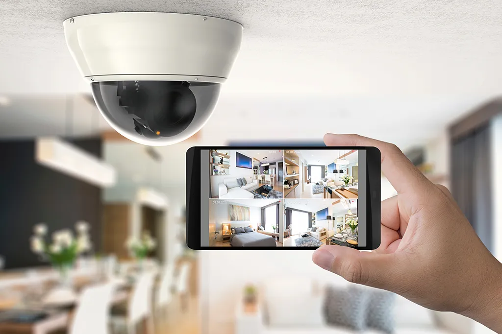 A dome cctv camera being monitored using a phone