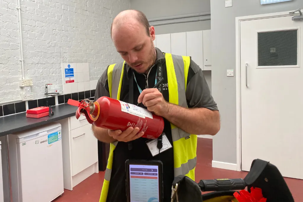 OHEAP engineer servicing a fire extinguisher
