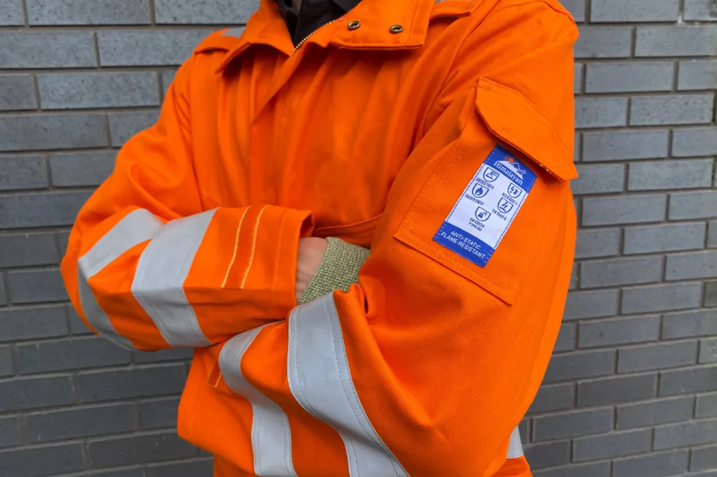 Engineer wearing specialised anti-static and flame-resistant high-visibility PPE