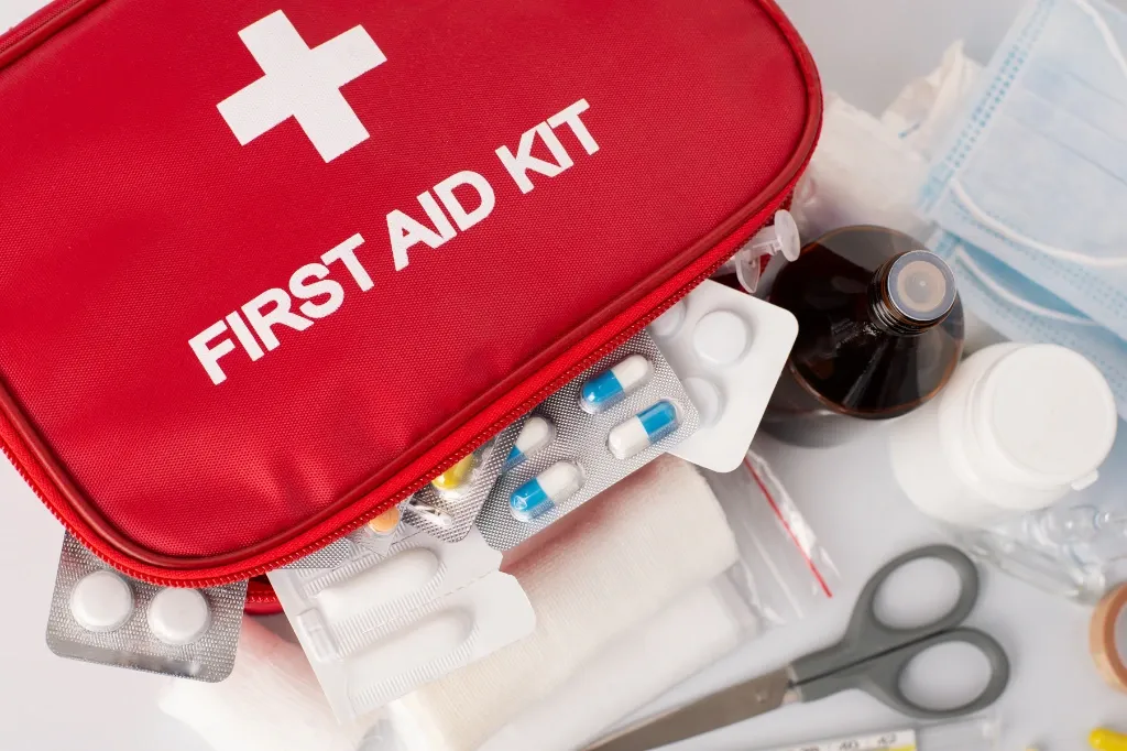 a first aid kit with equipment poking out