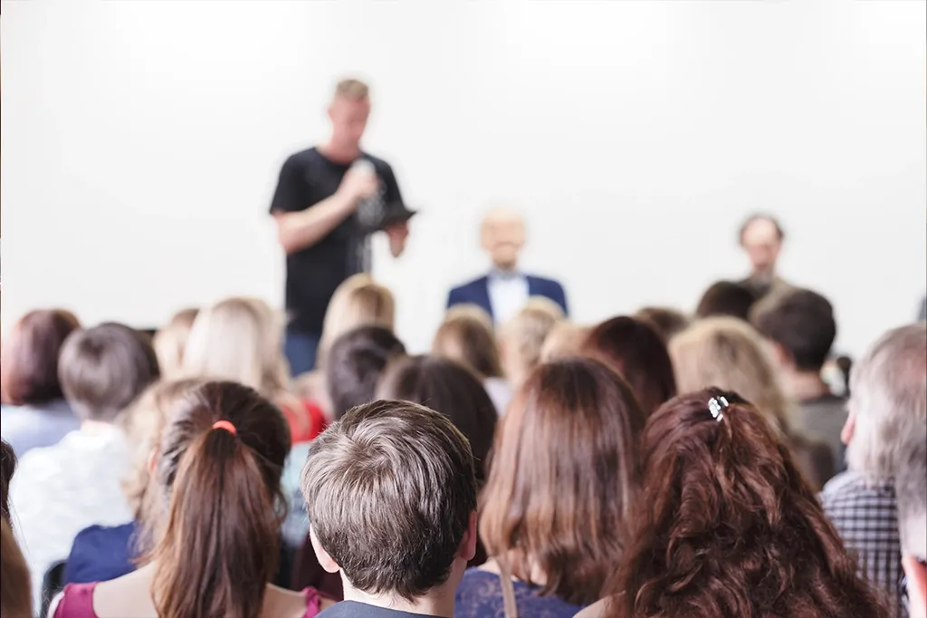 people watching a speaker in a confernece centre