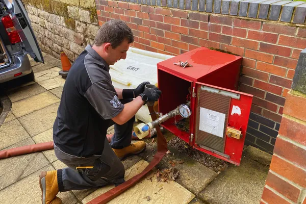 OHEAP Fire & Security engineer servicing a dry riser inlet