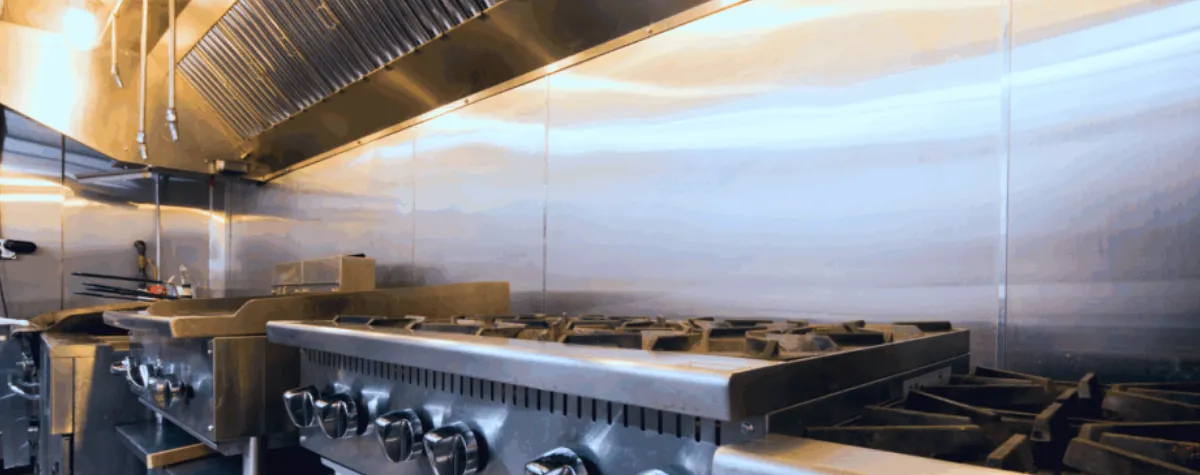 An Ansul kitchen suppression system installed in the hood of a commercial kitchen cooker to protect hospitality fire safety