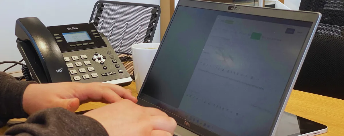 A fire risk assessor typing up a risk assessment report to ensure kitchen fire safety compliance