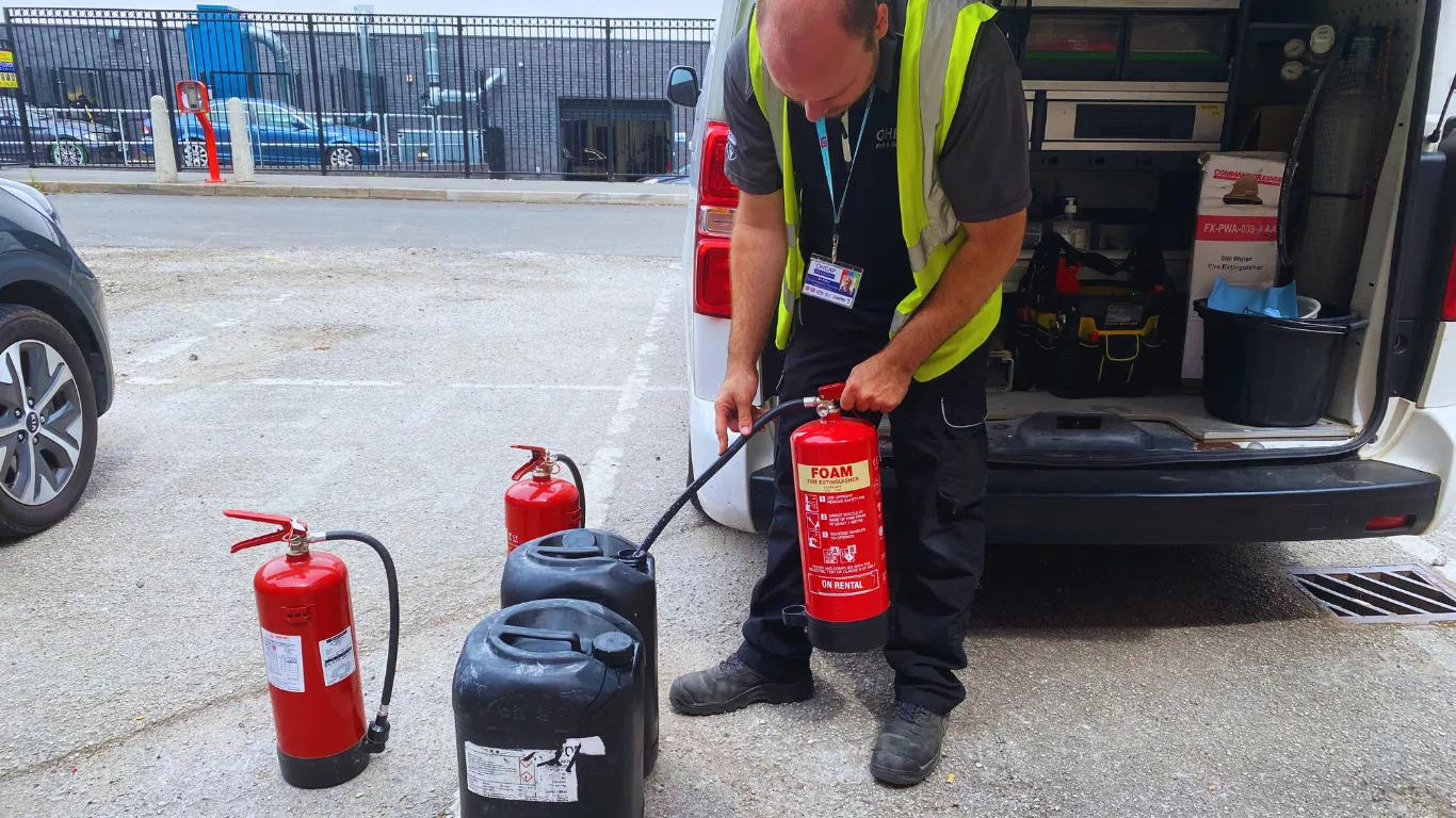 OHEAP fire protection engineer discharging a foam fire extinguisher safely