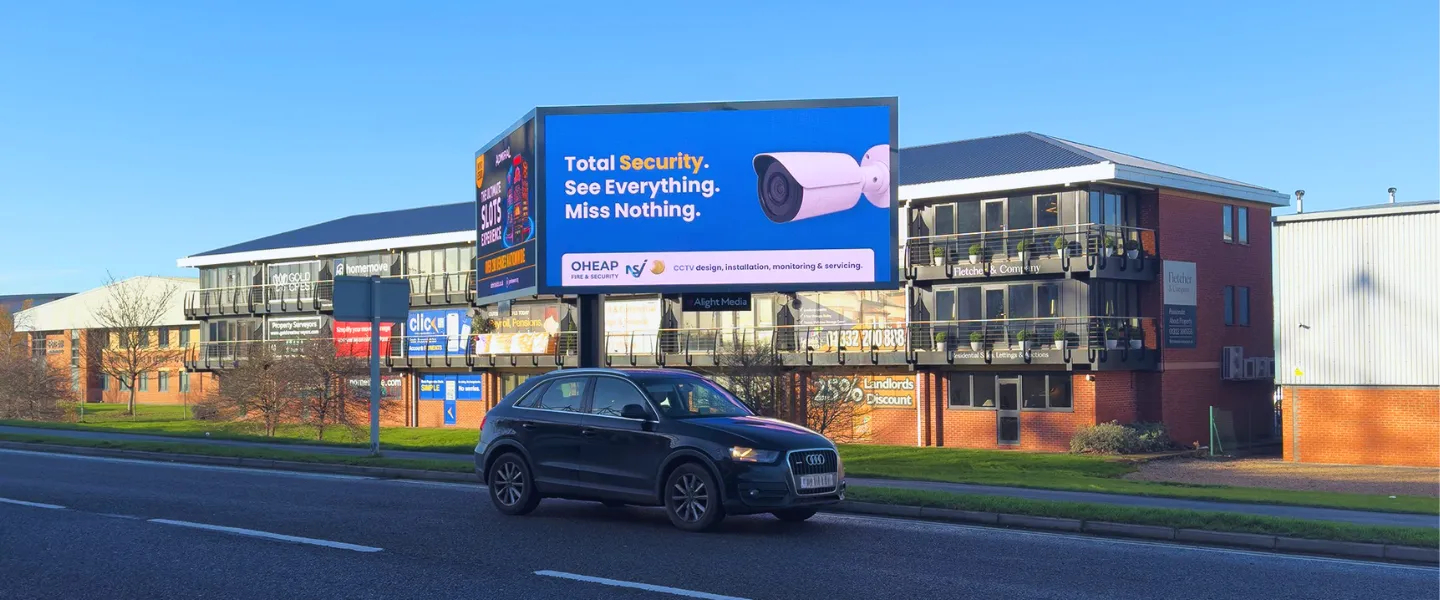A digital billboard displaying OHEAP Fire & Security's CCTV security system services