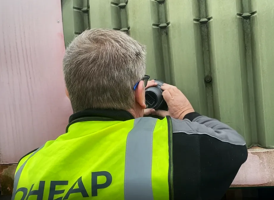 An OHEAP engineer installing CCTV