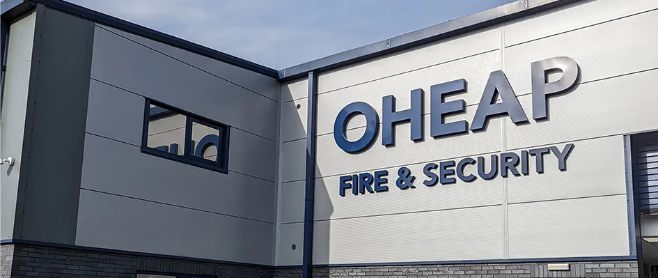 OHEAP Fire & Security sign on the side of a grey and blue building