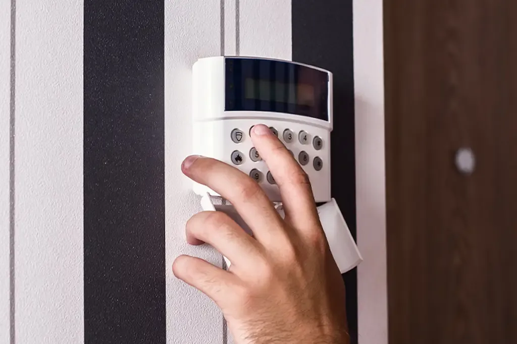 An intruder alarm keypad being set