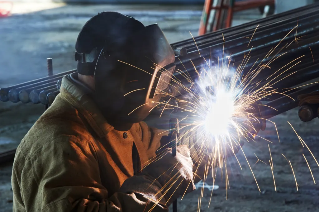 A welder wearing flame-retardant safety clothing