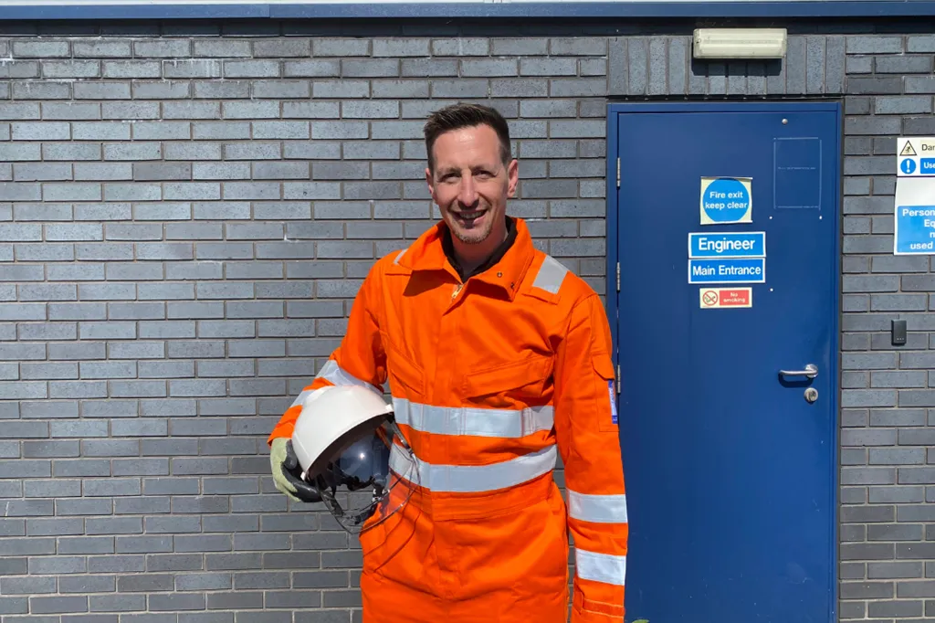 A worker wearing arc flash safety workwear clothing